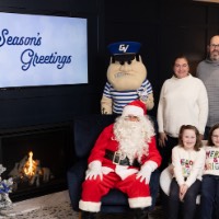 2 sisters with matching sweaters and family with Louie and Santa